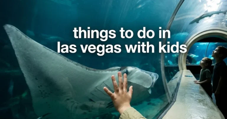 A child watches a manta ray glide overhead in an aquarium tunnel, highlighting smart things to do in las vegas with kids.