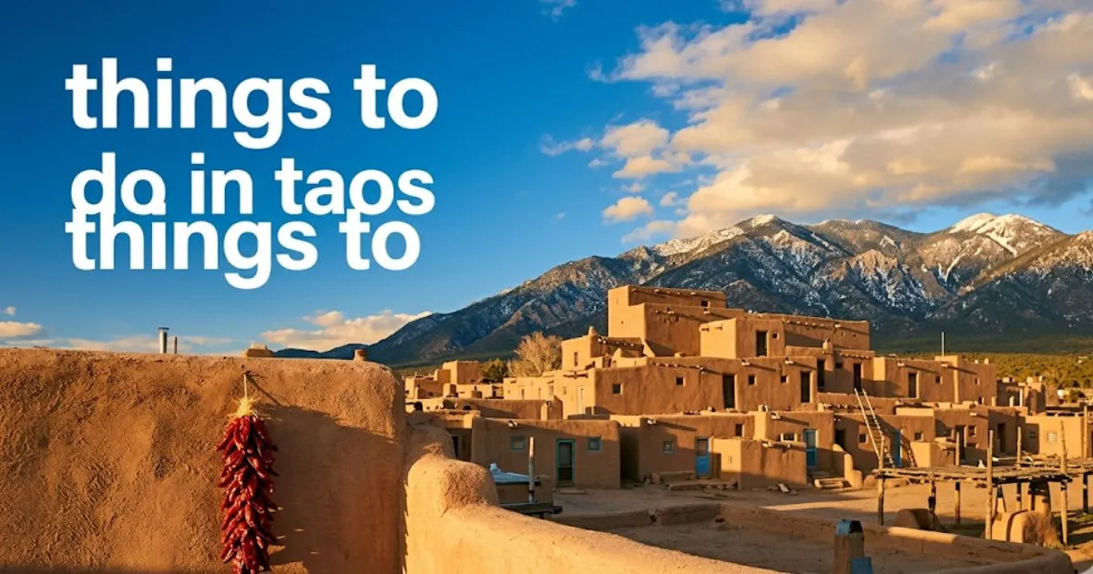 Red chile ristra on adobe wall with Taos Pueblo and mountains in background, editorial guide header things to do in taos.