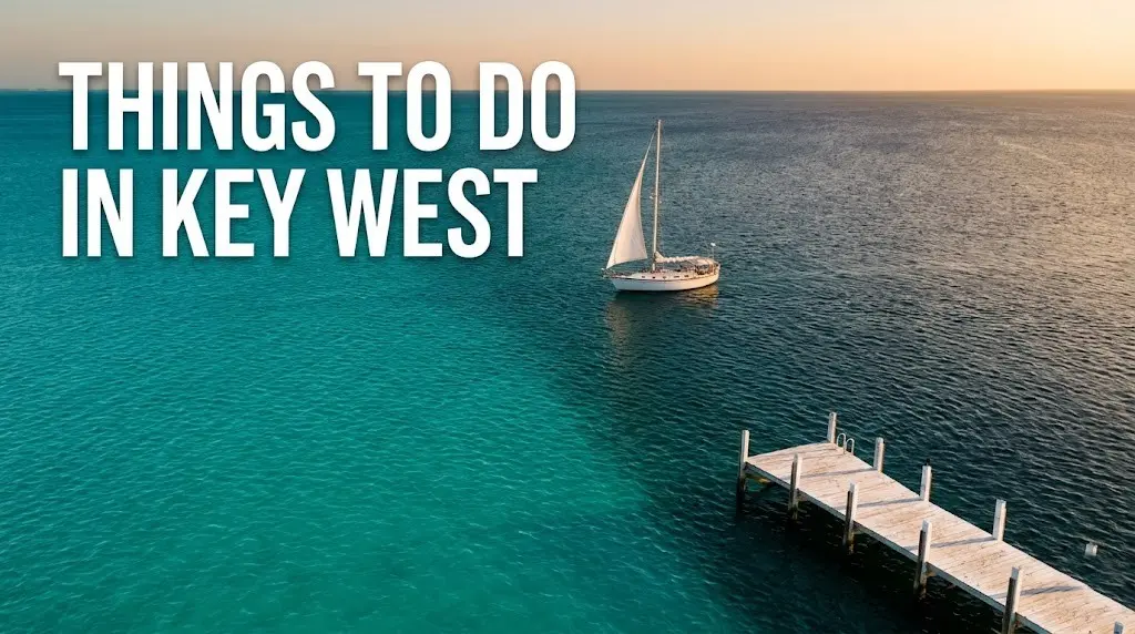 Things to do in Key West aerial view of turquoise waters, sailboat, and golden-hour sunset over the Florida Keys
